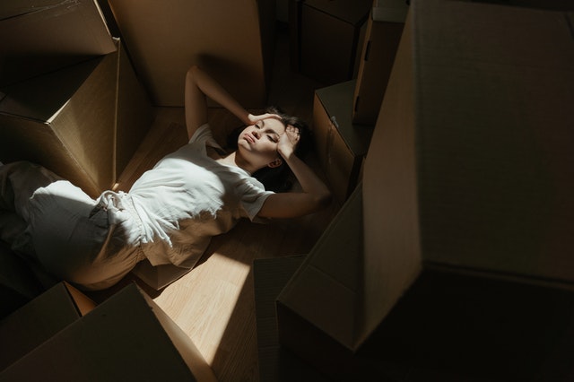 A woman surrounded by cardboard boxes